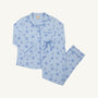 The Let Me Lounge Set - Eight Nights to Remember with Barbados Blue by The Beaufort Bonnet Company is a light blue Hanukkah pajama set featuring a button-up top and pants adorned with blue Stars of David, menorahs, dreidels, and wine glasses, displayed on a white background. Perfect for family matching pajamas or relaxing in this cozy Pima cotton lounge set.