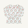 Long Sleeve Maude’s Peter Pan Collar Shirt - North Pole Portrait with Richmond Red by The Beaufort Bonnet Company: a children’s long-sleeve white shirt featuring a red-trimmed Peter Pan collar and a festive red and green Santa Claus wreath pattern, made from soft Pima cotton. The holiday outfit is laid flat on a plain background.