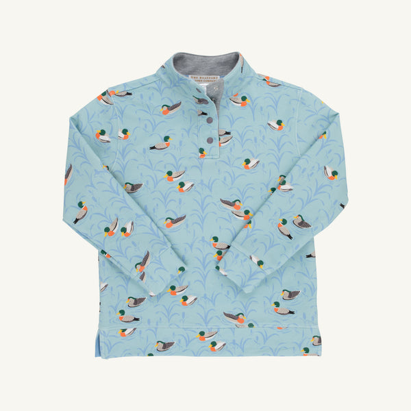 Pendleton’s Popped Collar - Fine Weather For Ducks with Grantley Gray by The Beaufort Bonnet Company is a light blue long-sleeve boys polo shirt featuring a charming duck pattern with light blue foliage. Crafted from soft cotton French terry, it includes a cozy inner lining and a stylish button-up collar, all set against a plain white background.