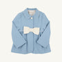 A light blue Pippa Peacoat by The Beaufort Bonnet Company in Barrington Blue with Palmetto Pearl, designed for toddlers and featuring long sleeves, a white Peter Pan collar trim, a single front button, and a large white bow at the waist.
