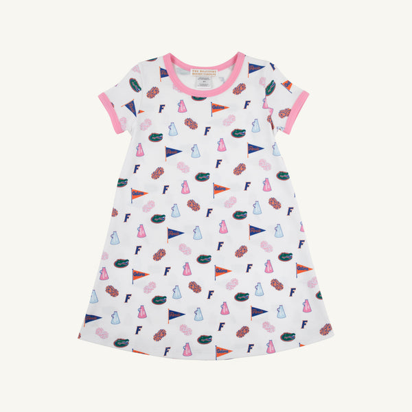 Introducing the Florida Polly Play Dress - Florida Forever with Hamptons Hot Pink by The Beaufort Bonnet Company, a white short-sleeve dress accented with vibrant pink trim. Adorned with a cheerful Florida Forever print featuring lab flasks, flags, donuts, the letter F, and brains arranged in a playful design. Made from soft Pima Cotton Knit for all-day comfort.