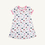 Introducing the Florida Polly Play Dress - Florida Forever with Hamptons Hot Pink by The Beaufort Bonnet Company, a white short-sleeve dress accented with vibrant pink trim. Adorned with a cheerful Florida Forever print featuring lab flasks, flags, donuts, the letter F, and brains arranged in a playful design. Made from soft Pima Cotton Knit for all-day comfort.