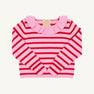 A long-sleeve girls’ sweater by The Beaufort Bonnet Company, the Reece Ruffle Sweater in Pier Party Pink & Richmond Red Stripe, featuring pink and red horizontal stripes and a ruffled pink collar, is displayed laid flat on a white background.