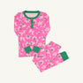 Sara Jane’s Sweet Dream Set - Bows of Holly with Kiawah Kelly Green by The Beaufort Bonnet Company features pink long-sleeve Pima cotton pajamas adorned with a white and green bows of holly pattern and finished with green cuffs and collar, displayed on a plain white background.