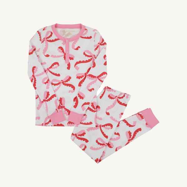 Sara Jane’s Sweet Dream Set - Bonnie Scot Bows with Hamptons Hot Pink: a white long-sleeved Pima cotton pajama set with a pink and red bow print, a henley neckline, and pink ribbed cuffs.