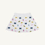 Introducing the Michigan Searcy Skort - Bold in Blue with Worth Avenue White by The Beaufort Bonnet Company, a stylish white Pima cotton skort featuring playful blue M letters, yellow flags, pink pom-poms, and megaphones for a fun school spirit and cheerleading vibe—the perfect new addition to your gameday outfit.