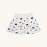 The Michigan Searcy Skort by The Beaufort Bonnet Company features Worth Avenue White Pima cotton with a comfortable elastic waistband and a bold, scattered pattern of blue “M” letters, yellow pennants, pink pom-poms, and megaphones—making it the perfect choice for a spirited gameday look.