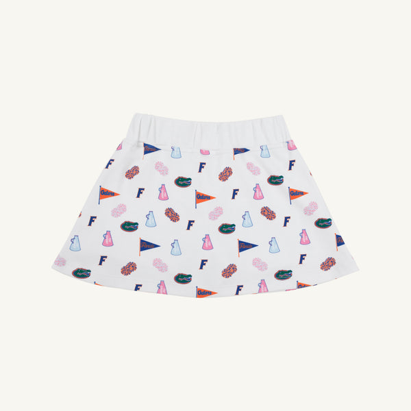 The Beaufort Bonnet Company’s Florida Searcy Skort – Florida Forever with Worth Avenue White features a soft Pima Cotton Knit fabric and a comfortable elastic waistband. The skort showcases a vibrant pattern of colorful University of Florida motifs—including pennants, F logos, cheer megaphones, and gator mascots—set against a crisp white background in the signature Florida Forever print.