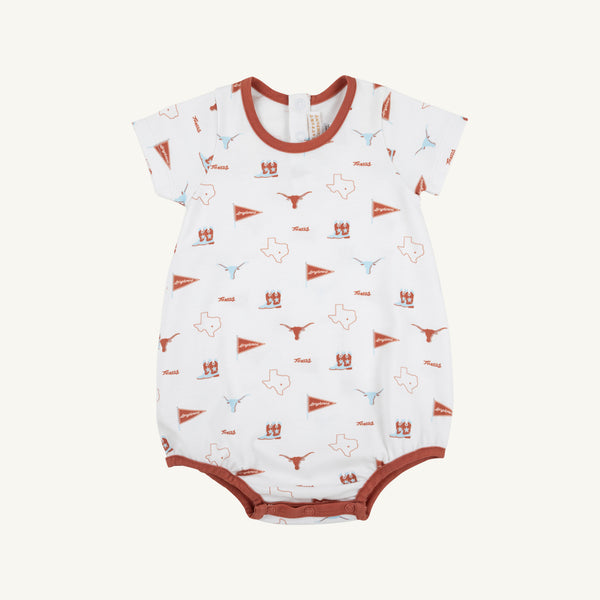 The Beaufort Bonnet Company’s “Texas Short Sleeve Patton Play Bubble - Gone to Texas with Texas Orange” is a white romper crafted from soft Pima Cotton, featuring brown trim and lively Texas-themed prints—such as flags, longhorns, football helmets, the word “Texas,” state outlines, and a playful “Gone to Texas” motif.