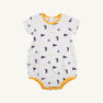 The LSU Short Sleeve Patton Play Bubble - Tenacious Tigers with LSU Gold by The Beaufort Bonnet Company is a white baby romper made from soft Pima Cotton, featuring short sleeves, yellow trim, and a playful all-over print of small tigers, purple pennants, and the word “TIGERS” in yellow throughout the fabric. Part of our Tenacious Tigers collection.