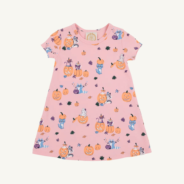 Introducing the Polly Play Dress - Candy & Critters (Sandpearl Pink) by The Beaufort Bonnet Company. This short-sleeve girls’ dress features whimsical Halloween-themed prints, including pumpkins, black cats, witches, ghosts, bats, and leaves in shades of purple, orange, and black. Made from soft Pima Cotton for lasting comfort and durability. Shown here displayed flat on a white background.