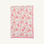 The Silent Night Throw - Gourd-geous (Palmetto Pearl) with Romany Rose by The Beaufort Bonnet Company features a cozy white design with a pink border, adorned with charming pink and orange pomegranates and vines, reminiscent of the comforting warmth of a waffle knit throw.
