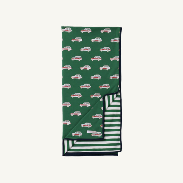 The Beaufort Bonnet Company’s Silent Night Throw in the Windsor Wagon (Grier Green) design features a cheerful pattern of red and white cars on top, with Palmetto Pearl & Grier Green stripes on the underside, both visible in the image.