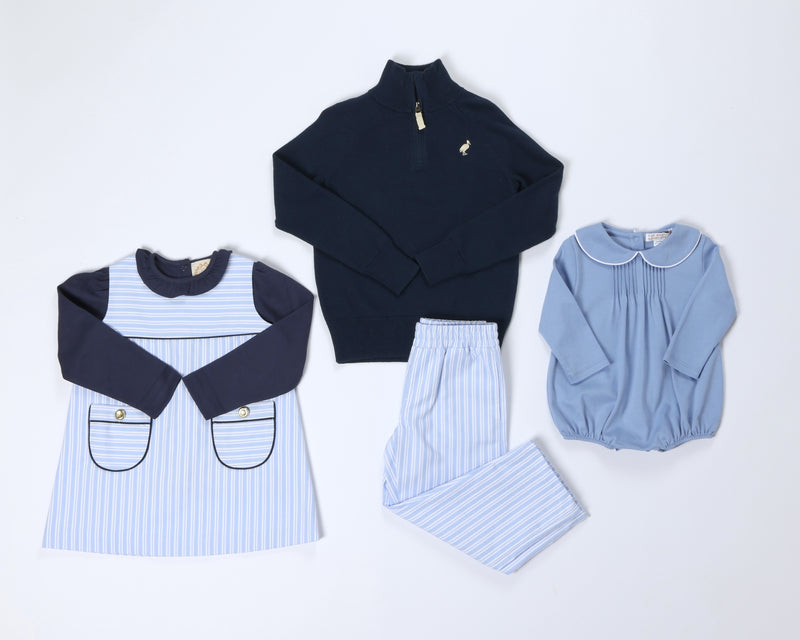 A Jill Jumper - Park City Periwinkle Stripe with Nantucket Navy, a navy quarter-zip sweater, striped pants, and a light blue long-sleeved bubble romper.