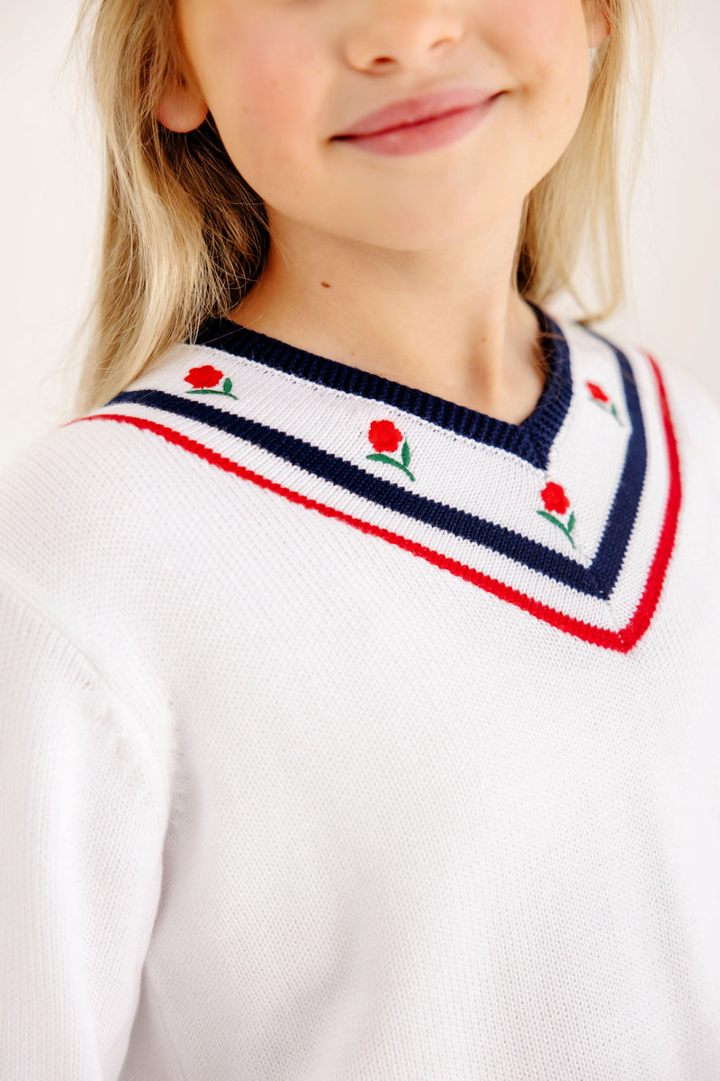 Vivie June V-Neck Sweater in Worth Avenue White with a navy and red striped neckline, accented by small red flower embroidery.
