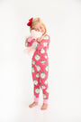 A young girl wears a Payton Pajama Set - Distinguished Doggies with Hamptons Hot Pink while hugging a plush toy.