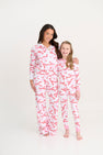 A woman and a young girl wearing matching Libby’s Lounge Set - Bonnie Scot Bows with Worth Avenue White, featuring wide leg pants and a pink ribbon print.