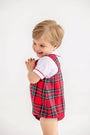 A toddler wearing a white Peter Pan collar shirt under a Barr Clay Bubble - Society Prep Plaid with Worth Avenue White & Richmond Red bubble romper.