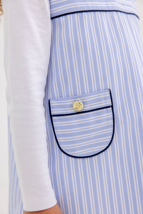 The Jill Jumper - Park City Periwinkle Stripe with Nantucket Navy is a light blue and white striped jumper featuring dark blue piping on the pocket and a gold button.