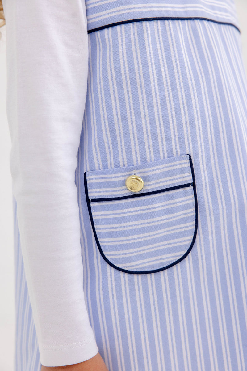 The Jill Jumper - Park City Periwinkle Stripe with Nantucket Navy is a light blue and white striped jumper featuring dark blue piping on the pocket and a gold button.