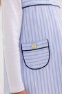 The Jill Jumper - Park City Periwinkle Stripe with Nantucket Navy is a light blue and white striped jumper featuring dark blue piping on the pocket and a gold button.