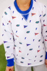 A child stands on green grass wearing The Beaufort Bonnet Company’s Florida Cassidy Comfy Crewneck – Florida Forever with Florida Blue, a white sweatshirt featuring blue collar and cuffs, accented with small University “F” logos and orange pennants.