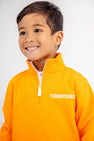 A smiling young boy wears The Beaufort Bonnet Company’s Tennessee Hayword Half-Zip in Tennessee Orange with Worth Avenue White, featuring “TENNESSEE” embroidered in white on the left chest—an ideal gameday layering piece for showcasing your Vols pride.