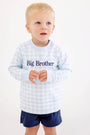 A toddler wears a Cassidy Comfy Crewneck - Buckhead Blue Gingham with Nantucket Navy Big Brother, a light blue and white gingham sweatshirt with navy embroidery paired with matching navy blue shorts for a sibling reveal outfit.