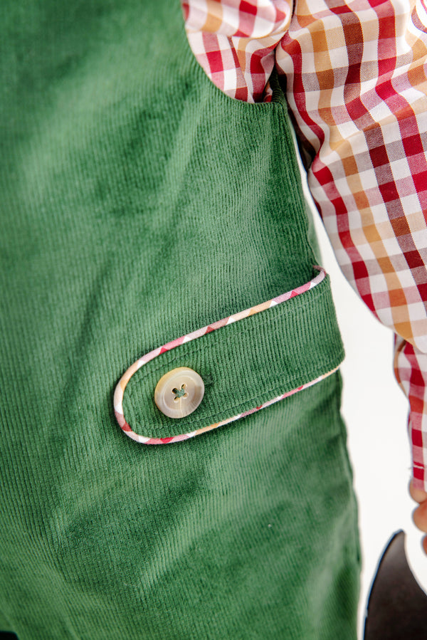 A close-up of The Beaufort Bonnet Company’s Ivy League Longall in Grier Green Corduroy, featuring a buttoned pocket flap and worn over an Easton Pond Plaid shirt in red, yellow, and white.
