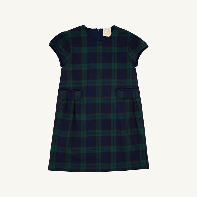 Betts Bow Dress - Berwick Black Watch with Nantucket Navy Velveteen Bows by The Beaufort Bonnet Company, a short-sleeved plaid dress with two small front pockets and a dark green and navy blue Berwick Black Watch checkered pattern, shown against a plain white background.