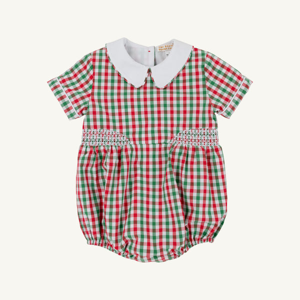 The Beaufort Bonnet Company’s Brentley Bubble in Richmond Red & Kiawah Kelly Green Gingham is a charming holiday baby romper featuring a festive red and green gingham pattern, short sleeves, a classic white Peter Pan collar, and smocked detailing at the waist—an adorable Christmas outfit for little ones.
