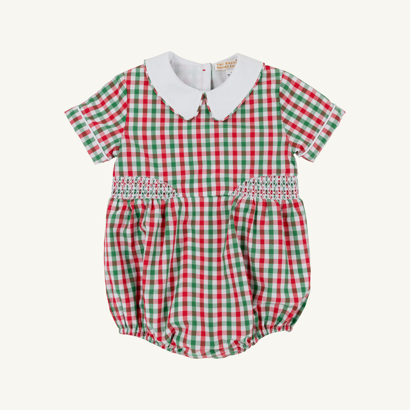 The Beaufort Bonnet Company’s Brentley Bubble in Richmond Red & Kiawah Kelly Green Gingham is a charming holiday baby romper featuring a festive red and green gingham pattern, short sleeves, a classic white Peter Pan collar, and smocked detailing at the waist—an adorable Christmas outfit for little ones.