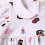 Close-up of The Beaufort Bonnet Company’s USC Britt Bubble – South Carolina Spirit with Palm Beach Pink, a white dress accented with pink trim. This soft Pima Cotton bubble features printed cheerleader pom-poms, a USC megaphone, and a rooster logo, highlighted by a scalloped collar for the perfect touch of spirited style.