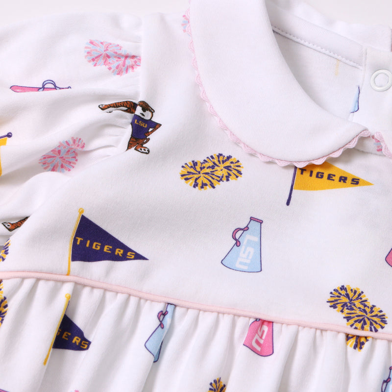 LSU Britt Bubble - Tenacious Tigers with Palm Beach Pink by The Beaufort Bonnet Company: A white pima cotton bubble featuring a playful Tenacious Tigers print with LSU and Tigers flags, pom-poms, and megaphones in purple, gold, and pink. This design includes puffed sleeves, a Peter Pan collar, light pink trim at the waist, and is crafted for comfort and Southern charm.