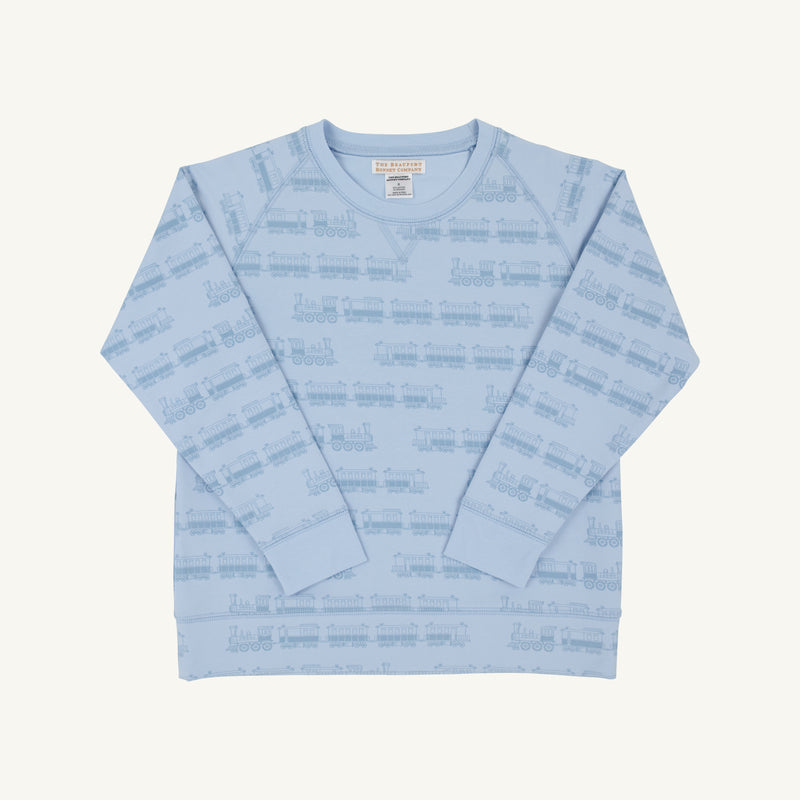 The Cassidy Comfy Crewneck - Blue Choo Choos by The Beaufort Bonnet Company is a light blue children’s sweatshirt with long sleeves, decorated with an outlined blue choo choo pattern. Displayed flat on a white background, the front side and inner label of this comfortable crewneck are visible.