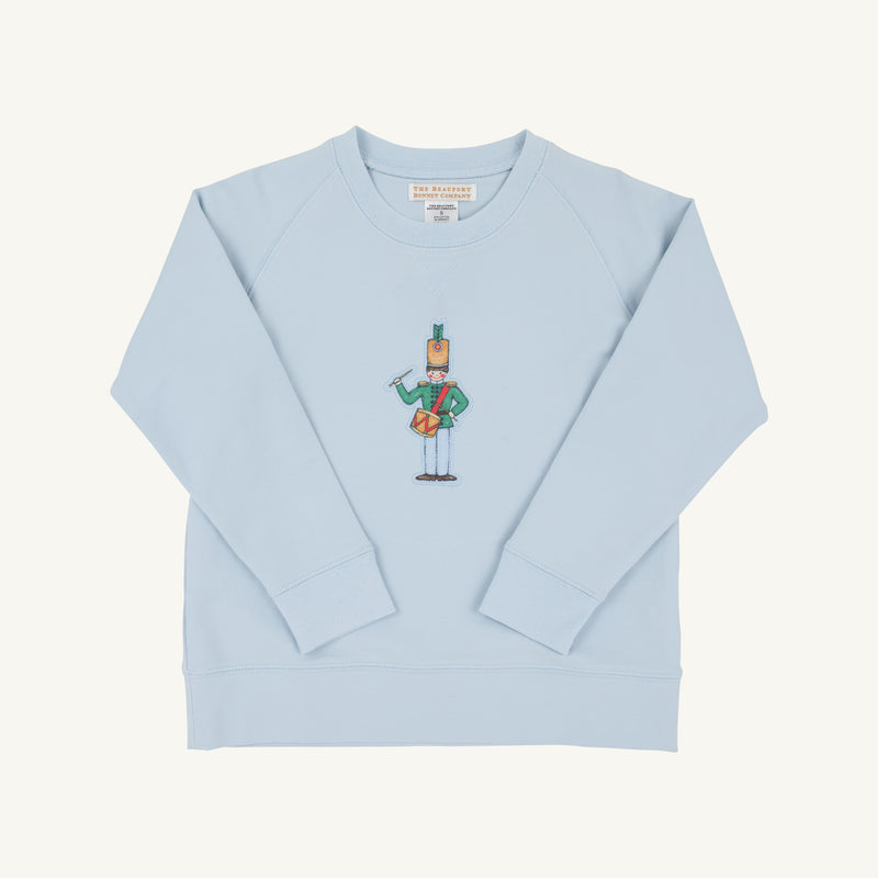 The Cassidy Comfy Crewneck by The Beaufort Bonnet Company features a charming “Drummer Boy” cartoon graphic on the front center and comes in a soft Buckhead Blue. This cozy sweatshirt has long sleeves and a classic crew neckline, making it perfect for everyday comfort.