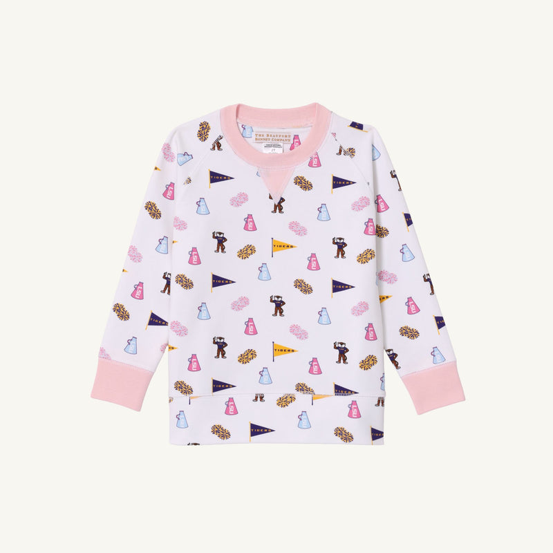 Cheer on the Tenacious Tigers in style with The Beaufort Bonnet Company’s LSU Cassidy Comfy Crewneck, featuring playful prints of cheerleaders, pennants, megaphones, and pom-poms on a white background, accented by Palm Beach Pink cuffs, collar, and hem—perfect for showing your school spirit!.