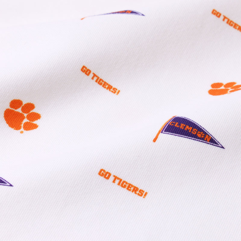 Close-up of white fabric featuring orange paw prints, “GO TIGERS!” text, and purple flags reading “CLEMSON” in a repeating pattern—perfect for The Beaufort Bonnet Company’s Clemson Cassidy Comfy Crewneck - Tiger Triumph with Clemson Orange.