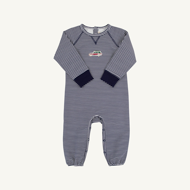 Cassidy Comfy Crewneck Romper in Nantucket Navy Stripe with long sleeves, long legs, navy cuffs, and a small colorful wagon embroidery on the chest by The Beaufort Bonnet Company, laid flat on a white background.