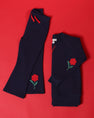 The Beaufort Bonnet Company Cassidy Comfy Crewneck - Nantucket Navy with Flowers shirt and matching pants in cotton spandex, both featuring embroidered red flowers with green stems.
