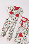 Two “Knox’s Night Night - 12 Days of Christmas with Richmond Red” pajamas by The Beaufort Bonnet Company, featuring festive prints such as nutcrackers, gingerbread men, swans, candy canes, and other holiday motifs on soft white Pima cotton with red cuffs and collars, are laid flat on a white surface—offering cozy holiday sleepwear for children.