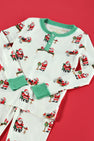 Sutton’s Sweet Dream Set - Serious Santa Business by The Beaufort Bonnet Company features playful Santa Claus and reindeer illustrations on a red background, complete with festive green cuffs and buttons, all crafted in cozy Pima cotton for the perfect Christmas pajama set.