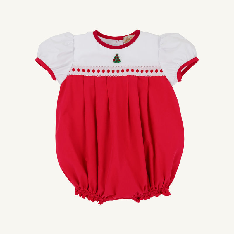 The Cindy Lou Bubble by The Beaufort Bonnet Company features Richmond Red and Worth Avenue White with puff sleeves, red trim, smocked detailing, and a small embroidered Christmas tree on the chest—making it the perfect cheerful holiday outfit for your baby.