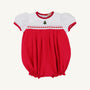 The Cindy Lou Bubble by The Beaufort Bonnet Company features Richmond Red and Worth Avenue White with puff sleeves, red trim, smocked detailing, and a small embroidered Christmas tree on the chest—making it the perfect cheerful holiday outfit for your baby.