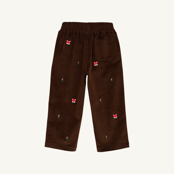 The Critter Sheffield Pants - Chelsea Chocolate Corduroy with Fox Embroidery by The Beaufort Bonnet Company are crafted from chocolate corduroy and feature an elastic waistband, a single back pocket, and charming fox embroidery with small green leaves scattered across the fabric.
