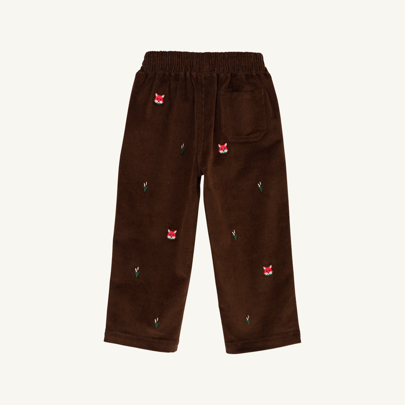 The Critter Sheffield Pants - Chelsea Chocolate Corduroy with Fox Embroidery by The Beaufort Bonnet Company are crafted from chocolate corduroy and feature an elastic waistband, a single back pocket, and charming fox embroidery with small green leaves scattered across the fabric.