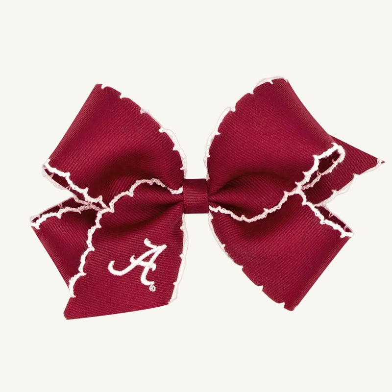 A Wee Ones Hair Bow - University of Alabama by The Beaufort Bonnet Company, featuring a crimson hue with white ruffled edges and an embroidered white script A logo on one loop, is displayed against a plain background. This Game Day accessory is perfect for adding school spirit to any outfit.