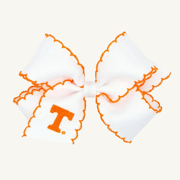 Introducing the Wee Ones Hair Bow - University of Tennessee by The Beaufort Bonnet Company, this collegiate accessory features crisp white fabric accented with orange stitching along the edges and showcases an orange T logo on one tail, symbolizing UT pride.