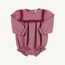 The Debbie Day Bubble in Begley Berry Tweed by The Beaufort Bonnet Company features a charming pink patterned fabric with ruffled trim on the chest and leg openings, plus convenient bottom snaps for easy diaper changes—an adorable baby girl outfit perfect for autumn.