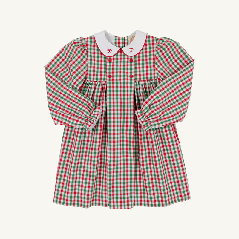 Introducing the Della Marie Dress in Richmond Red & Kiawah Kelly Green Gingham by The Beaufort Bonnet Company. This girls’ holiday dress features a charming red, green, and white plaid pattern with a gathered waist and a classic white collar adorned with sweet red bows—perfect for festive occasions this Christmas season.